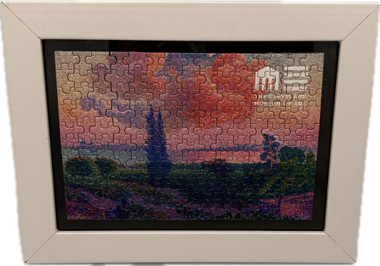 Framed puzzle with a sunset scene in a decorative frame