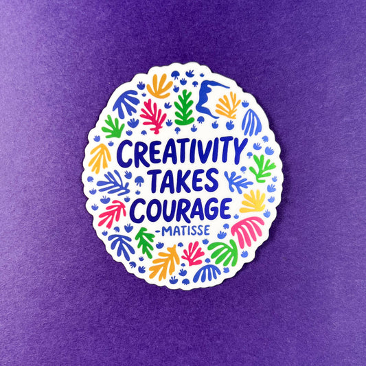 Circular sticker with colorful hand cut prints and text 'Creativity takes courage - Matisse' on a purple background
