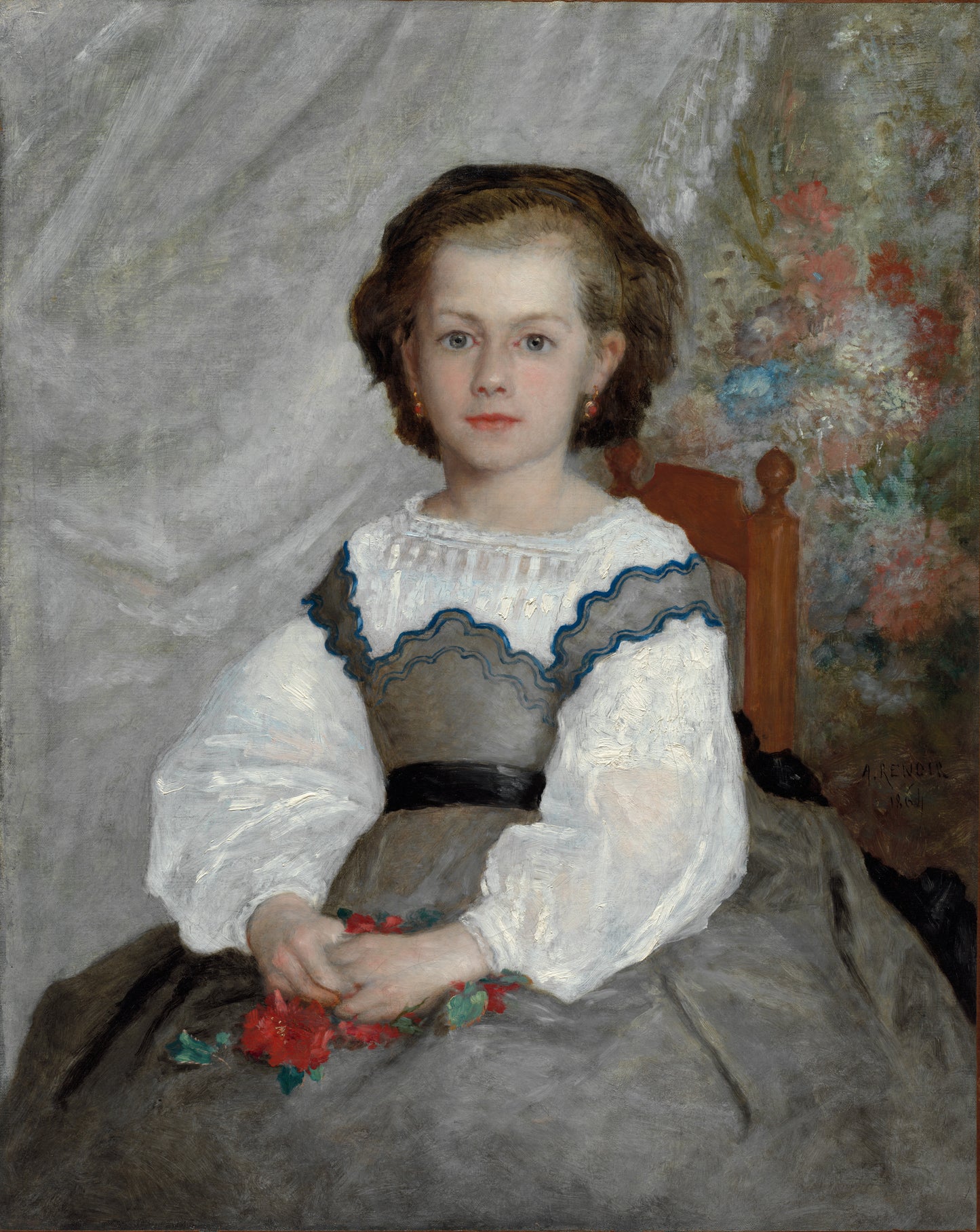 Portrait of a young girl in a gray dress with white lace sleeves, holding flowers, against a textured wall.