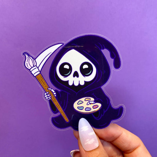 Sticker of a cute skeleton in a purple hood holding a paintbrush and palette on a purple background.