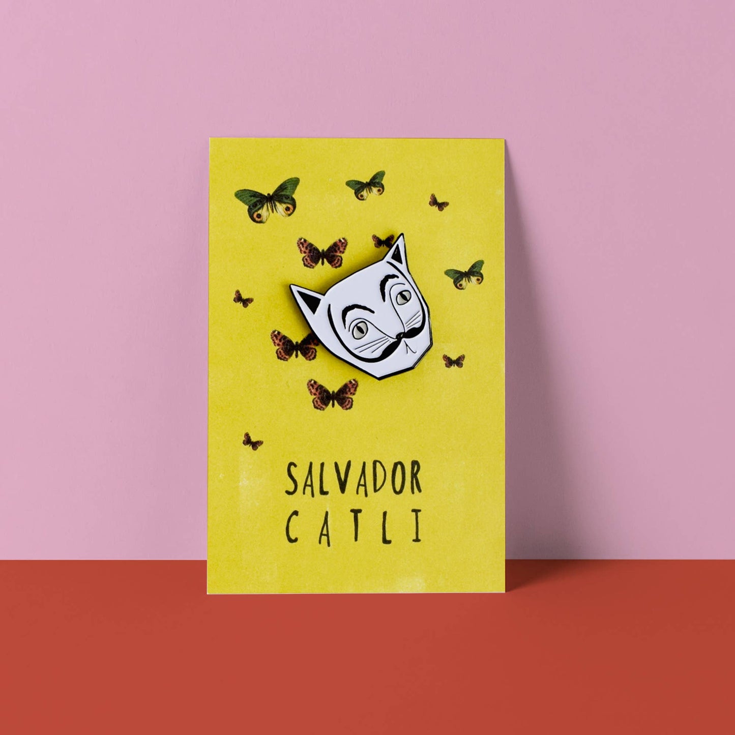 Yellow card with a white mask and butterflies on a pink and red background
