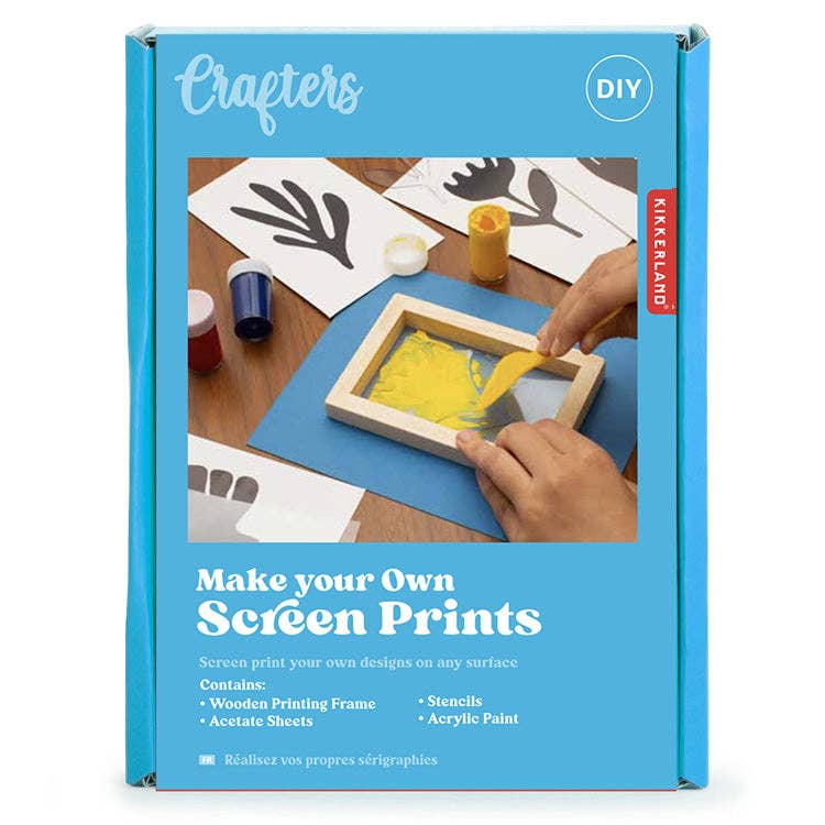 Kikkerland screen printing kit packaging with a person making screen prints on a table.