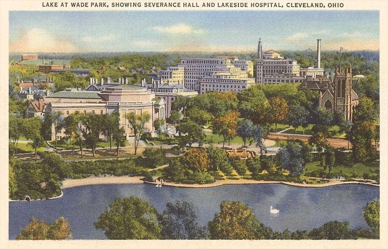 Vintage postcard depicting a view of Lake at Wade Park in Cleveland, Ohio, showing buildings and a body of water.