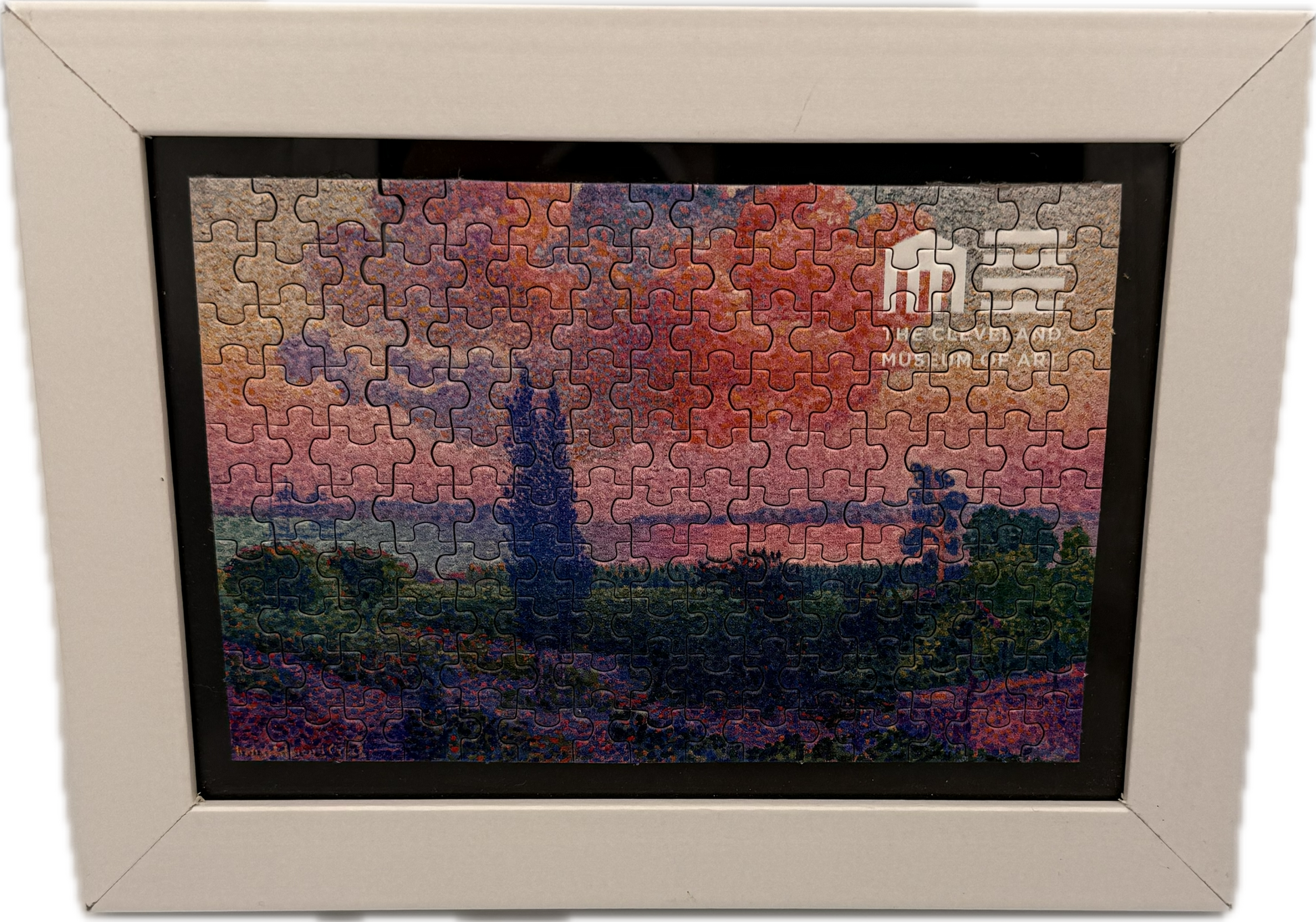 Framed puzzle with a sunset scene in a decorative frame