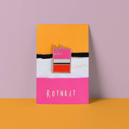 Enamel pin on a card with 'ROTHKAT' branding against a pink and orange background